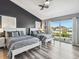 Stylish bedroom with two beds, a ceiling fan, a sliding glass door with curtains, and wood-look flooring at 6241 Bayside Dr, New Port Richey, FL 34652