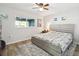 This bedroom features hardwood floors, a ceiling fan, and a serene, light-filled ambiance at 6241 Bayside Dr, New Port Richey, FL 34652