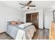 Bedroom with gray bedding, wood floors, closet, and a ceiling fan at 6241 Bayside Dr, New Port Richey, FL 34652