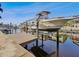 View of a boat lift with a boat over a canal, showcasing waterfront living at 6241 Bayside Dr, New Port Richey, FL 34652