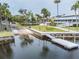 Community boat launch and dock on the water, with lush landscaping at 6241 Bayside Dr, New Port Richey, FL 34652