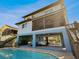 A multi-story home featuring a swimming pool and an enclosed patio, providing a perfect indoor-outdoor experience at 6241 Bayside Dr, New Port Richey, FL 34652