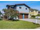 Charming two-story home with a well-maintained lawn and a two-car garage, located on a scenic street at 6241 Bayside Dr, New Port Richey, FL 34652