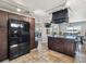 Spacious kitchen featuring a large island with a cooktop, stainless steel appliances, and beautiful tile flooring at 6241 Bayside Dr, New Port Richey, FL 34652