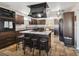 Well-equipped kitchen featuring a central island with barstool seating, sleek appliances, and granite counter tops at 6241 Bayside Dr, New Port Richey, FL 34652