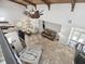 Open-concept living room with wood-beamed ceilings, tile floors, and a comfortable seating arrangement at 6241 Bayside Dr, New Port Richey, FL 34652