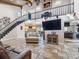 Large, inviting living room featuring an open floor plan, fireplace, and stairs to an upper level at 6241 Bayside Dr, New Port Richey, FL 34652