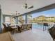 Covered outdoor seating area looks over pool and waterfront homes with beautiful landscaping at 6241 Bayside Dr, New Port Richey, FL 34652