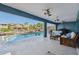 Inviting patio featuring comfortable seating, a barbecue grill, and a sparkling pool overlooking the canal at 6241 Bayside Dr, New Port Richey, FL 34652