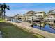 Picturesque waterfront view showcasing boat dock and lift next to lush green lawns at 6241 Bayside Dr, New Port Richey, FL 34652