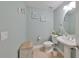 Stylish half bath features a pedestal sink and nautical decor at 6407 Mayra Shores Ln, Apollo Beach, FL 33572