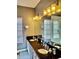 Bright bathroom with granite countertops, double sinks, and modern lighting at 6407 Mayra Shores Ln, Apollo Beach, FL 33572
