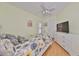 Cozy bedroom with a ceiling fan, a window, and a dresser with a TV at 6407 Mayra Shores Ln, Apollo Beach, FL 33572