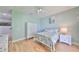 Serene bedroom with coastal accents, light-colored walls and hardwood floors at 6407 Mayra Shores Ln, Apollo Beach, FL 33572