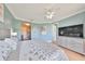 Comfortable bedroom boasts a ceiling fan and a large TV at 6407 Mayra Shores Ln, Apollo Beach, FL 33572