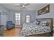 Comfortable bedroom with a ceiling fan, a window, and a dresser with a TV at 6407 Mayra Shores Ln, Apollo Beach, FL 33572