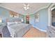 Spacious bedroom with hardwood floors, soft colors, and access to a private office space at 6407 Mayra Shores Ln, Apollo Beach, FL 33572