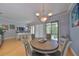 Elegant dining room featuring a round table, gray chairs, and sliding glass doors to an outdoor balcony at 6407 Mayra Shores Ln, Apollo Beach, FL 33572