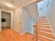 Spacious hallway with hardwood floors and a staircase leading to the upper level at 6407 Mayra Shores Ln, Apollo Beach, FL 33572