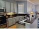 Well-equipped kitchen with stainless steel appliances, dark countertops, and ample cabinet space at 6407 Mayra Shores Ln, Apollo Beach, FL 33572