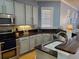 Well-equipped kitchen with stainless steel appliances, dark countertops, and ample cabinet space at 6407 Mayra Shores Ln, Apollo Beach, FL 33572