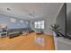 Bright living room with a gray sectional sofa, ceiling fan, and large windows at 6407 Mayra Shores Ln, Apollo Beach, FL 33572