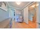 Bright home office with hardwood floors, light blue walls, chair, artwork, and closet access at 6407 Mayra Shores Ln, Apollo Beach, FL 33572