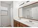 Bathroom featuring double sinks, ample counter space, and a large mirror at 7350 Lumber Port Dr, Ruskin, FL 33573