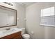 Well-lit half bath features a modern vanity, granite countertop, window and neutral paint at 7350 Lumber Port Dr, Ruskin, FL 33573