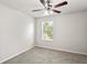 Bedroom featuring neutral carpet, a ceiling fan, and natural light from a window at 7350 Lumber Port Dr, Ruskin, FL 33573