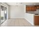 Bright dining area features a modern chandelier, sliding glass door, tile floor and kitchen view at 7350 Lumber Port Dr, Ruskin, FL 33573