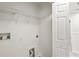 Laundry room with plumbing hookups, shelving, and door to the house at 7350 Lumber Port Dr, Ruskin, FL 33573