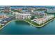 Aerial view showcases the beautiful waterfront condo complex with lush landscaping and community parking at 7700 Sun Island S Dr # 404, South Pasadena, FL 33707