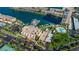 Aerial view featuring a pool, marina, and parking near the building at 7700 Sun Island S Dr # 404, South Pasadena, FL 33707