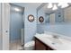 Cozy bathroom with blue walls, decorative wall art, and a convenient washer and dryer combo at 7700 Sun Island S Dr # 404, South Pasadena, FL 33707