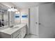Bathroom featuring white cabinets, and a wide mirror at 7700 Sun Island S Dr # 404, South Pasadena, FL 33707