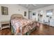 Bedroom with floral bedding, wicker furniture, view of the bathroom, and a desk at 7700 Sun Island S Dr # 404, South Pasadena, FL 33707