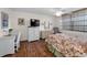 Bedroom with floral bedding, wicker furniture, and a view of the city at 7700 Sun Island S Dr # 404, South Pasadena, FL 33707