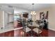 Dining room features glass table, chandelier, and decorative mirrors showing a glimpse of the kitchen and doorway at 7700 Sun Island S Dr # 404, South Pasadena, FL 33707