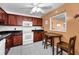 Kitchen featuring a white ceiling fan, wooden cabinets, white appliances, and a cozy breakfast nook at 7700 Sun Island S Dr # 404, South Pasadena, FL 33707