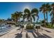 Community outdoor grills with shade umbrellas in a lush tropical setting at 7700 Sun Island S Dr # 404, South Pasadena, FL 33707