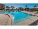 Sparkling community pool with ample lounge chairs and clear blue water at 7700 Sun Island S Dr # 404, South Pasadena, FL 33707