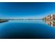 Scenic view of the calm waterfront with condos in the distance under a clear blue sky at 7700 Sun Island S Dr # 404, South Pasadena, FL 33707