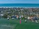 Breathtaking aerial view of waterfront home with private dock and Gulf of Mexico backdrop at 785 Bay Esplanade, Clearwater Beach, FL 33767