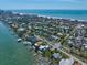Scenic aerial view of stunning waterfront houses with private docks, surrounded by lush greenery and a calming ocean view at 785 Bay Esplanade, Clearwater Beach, FL 33767