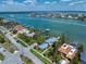 Expansive aerial view of waterfront homes with private docks, set against the backdrop of a tranquil bay and coastal community at 785 Bay Esplanade, Clearwater Beach, FL 33767