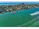 Scenic aerial view of waterfront homes along a vibrant coastline, showcasing the property's prime coastal location at 785 Bay Esplanade, Clearwater Beach, FL 33767