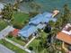 Beautiful aerial view of home showcasing the meticulously landscaped grounds, and a pristine metal roof at 785 Bay Esplanade, Clearwater Beach, FL 33767