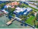 Expansive waterfront property showcasing a private dock, lush greenery, and stunning architectural design at 785 Bay Esplanade, Clearwater Beach, FL 33767
