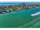 Scenic aerial view of waterfront homes along a vibrant coastline, showcasing the property's prime coastal location at 785 Bay Esplanade, Clearwater Beach, FL 33767